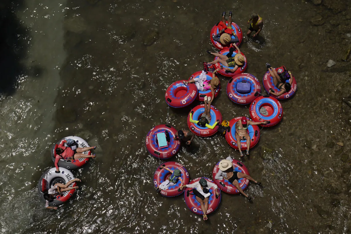 Tubers float the cool Comal River in New Braunfels, Texas, on June 29, 2023. (Eric Gay/AP Photo)