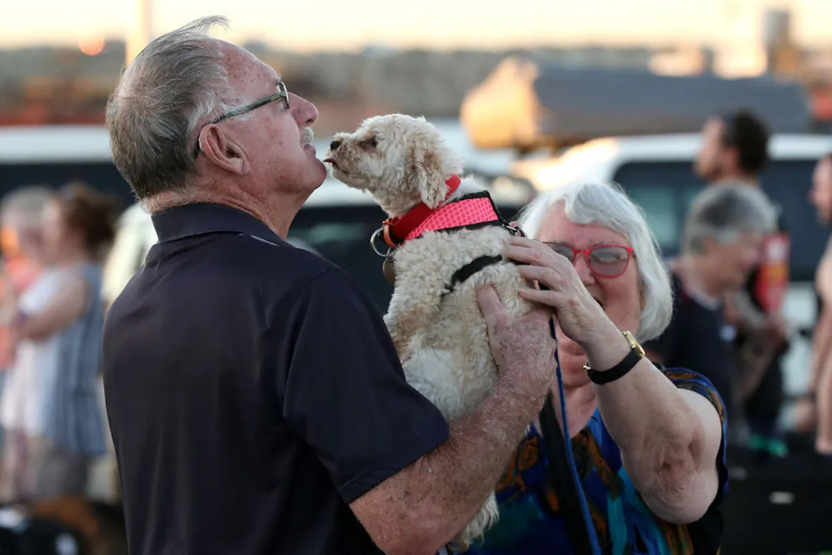 Passengers from the Vasco da Gamma reunite with their pet dog after returning from quarantine on Rottnest Island at the Northport Ferry Terminal in Fremantle in Western Australia on April 10, 2020. (Paul Kane/Getty Images)
