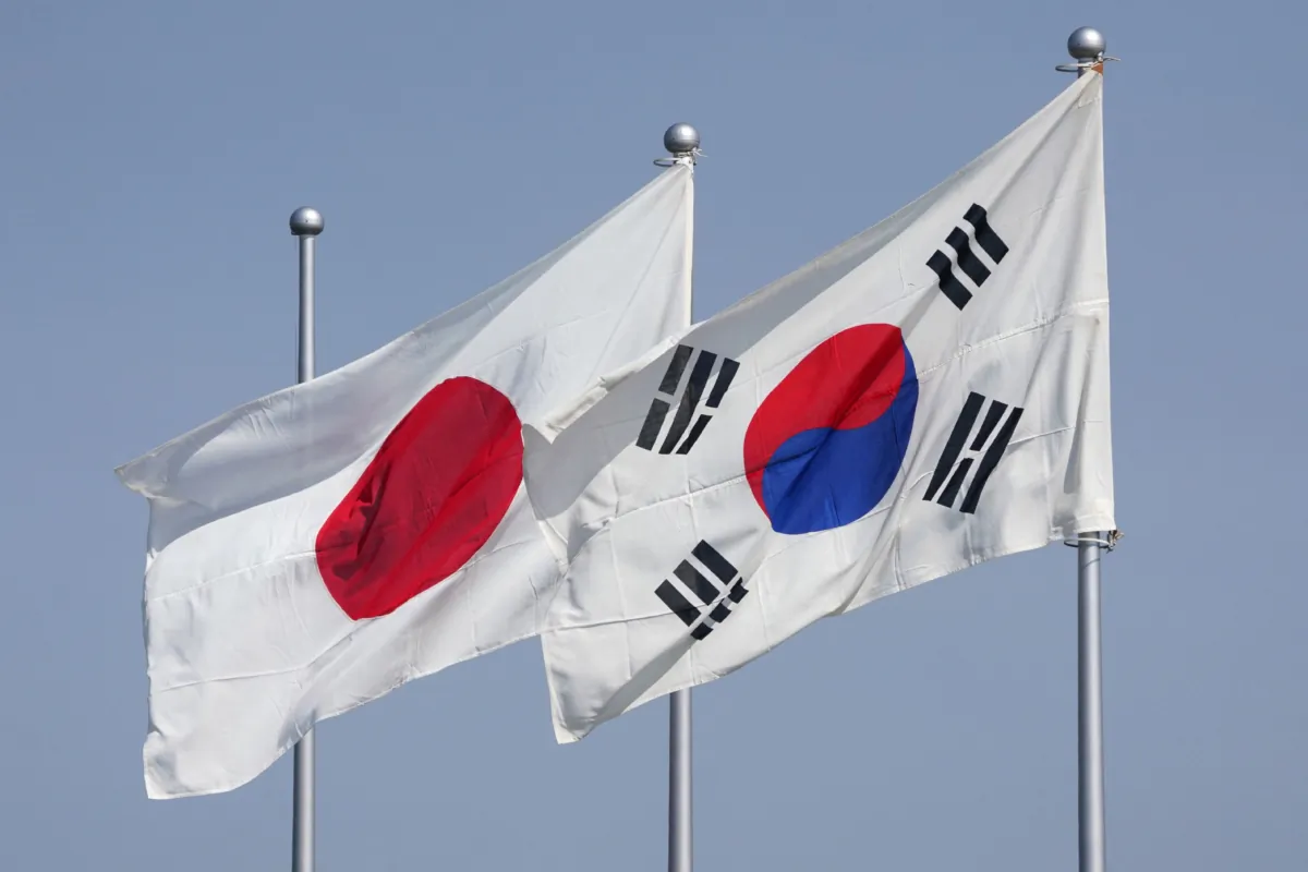The national flags of Japan (L) and South Korea (R) flutter in the wind ahead of the arrival of South Korean President Yoon Suk Yeol at Haneda Airport in Tokyo, Japan, on March 16, 2023. (Kazuhiro Nogi/AFP via Getty Images)