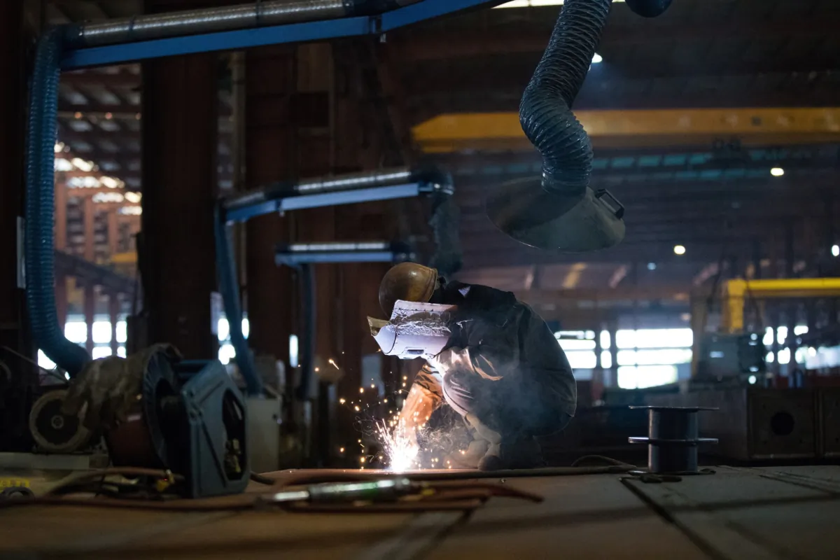 An employee works at a steel processing production line at a factory in Hefei, Anhui province, China, on Feb. 21, 2020. (China Daily via Reuters)