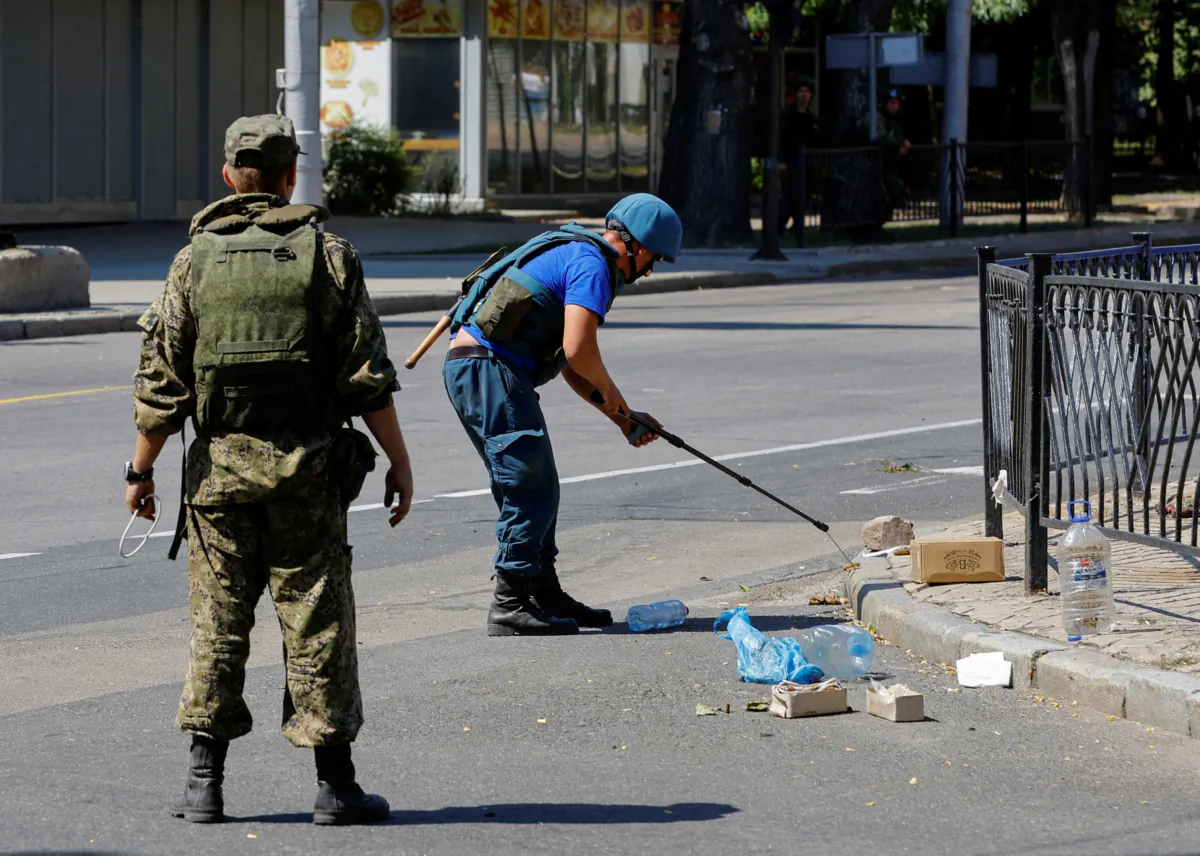 Combat engineers of pro-Russian troops demine PMF-1 Lepestok anti-personnel landmines on a street in Donetsk, Ukraine, on July 31, 2022. (Alexander Ermochenko/Reuters)