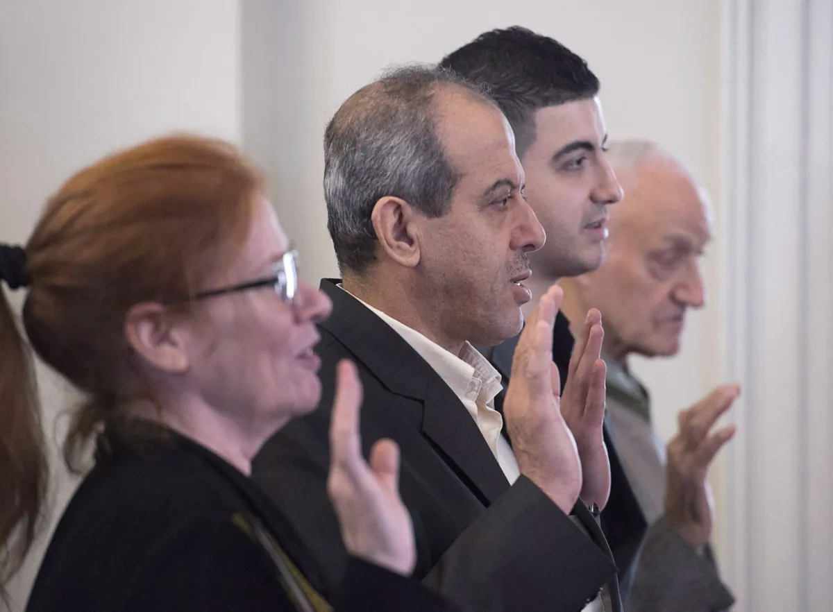 New Canadian citizens take an oath at a ceremony hosted by Immigration, Refugees and Citizenship Canada at Government House in Halifax on Nov. 20, 2017. (Andrew Vaughan/The Canadian Press)