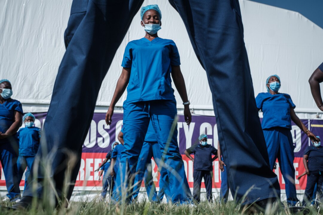 Health care providers—nurses, doctors, midwives, and health care workers—attend the 4th Zumba dance session organized by the Nursing Council of Kenya at Kenyatta stadium where screening booths and an isolation field hospital are installed for the COVID-19 coronavirus in Machakos, Kenya, on June 19, 2020. Organization (WHO). (Photo by YASUYOSHI CHIBA/AFP via Getty Images)