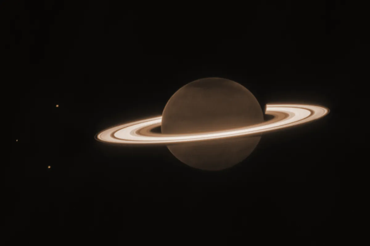 The planet Saturn and three of its moons, from left, Enceladus, Tethys and Dione, captured by the James Webb Space Telescope in June 2023. (NASA, ESA, CSA, JWST Saturn Team via AP)