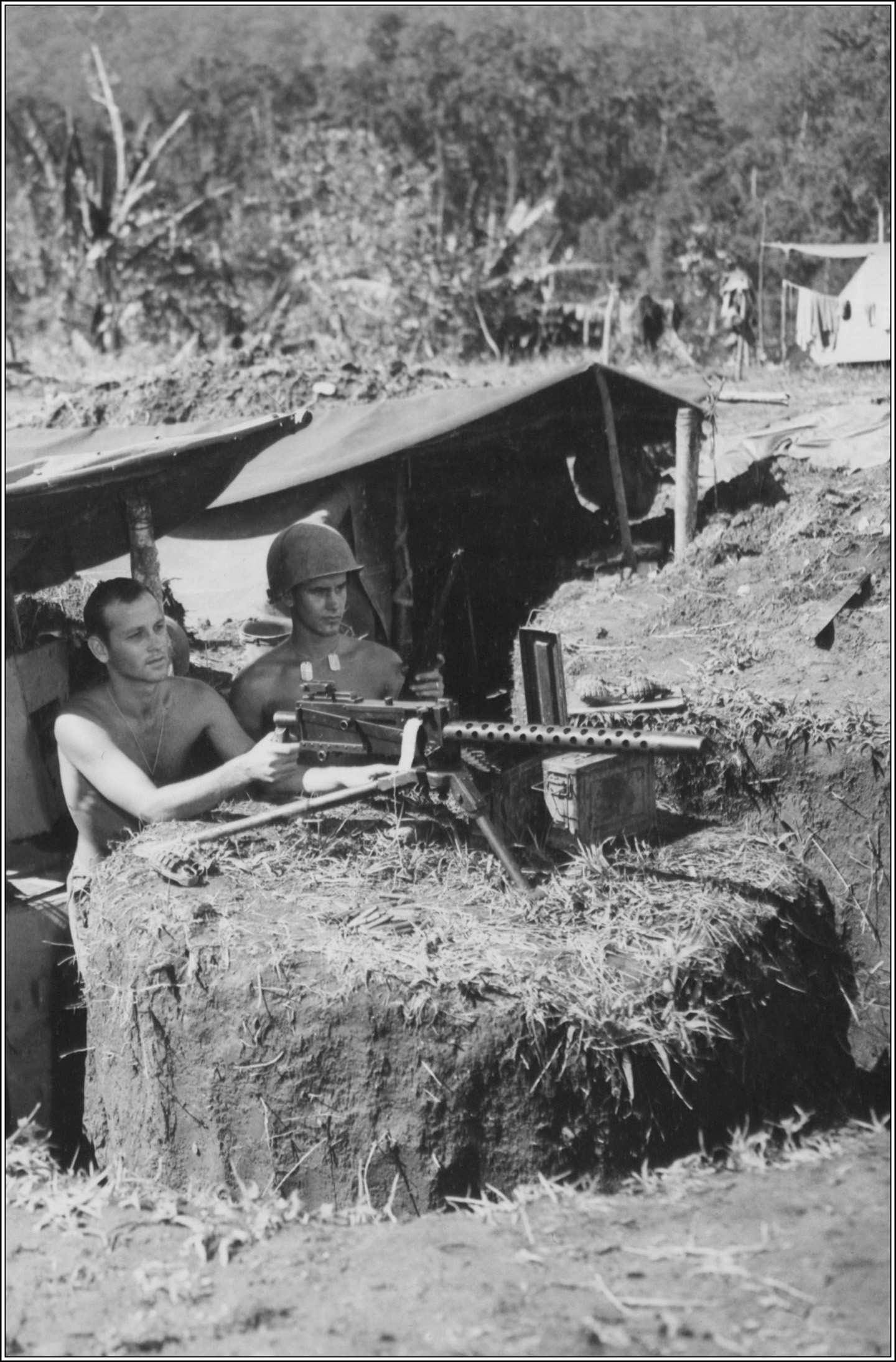 Sergeant Don Singery and Corporal John D. Moore man a .30- caliber machinegun on Manarawat’s perimeter