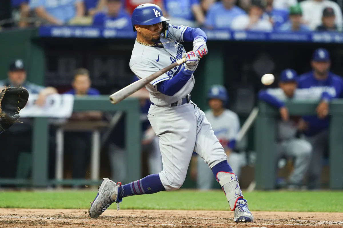 Mookie Betts (50) of the Los Angeles Dodgers hits a single against the Kansas City Royals that scores Jason Heyward (23) during the fourth inning at Kauffman Stadium in Kansas City on June 30, 2023. (Kyle Rivas/Getty Images)
