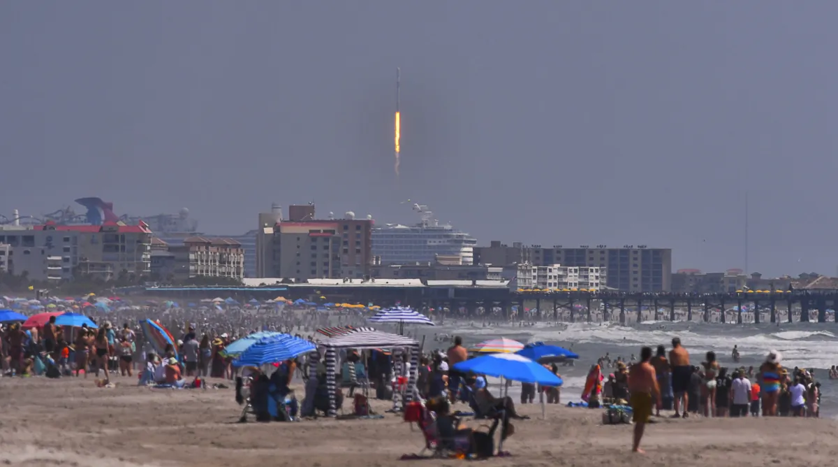 Crowds on the beach in Cocoa Beach, Fla., watch the launch of a SpaceX Falcon 9 rocket for the European Space Agency with the Euclid space telescope, on July 1, 2023. (Malcolm Denemark/Florida Today via AP)