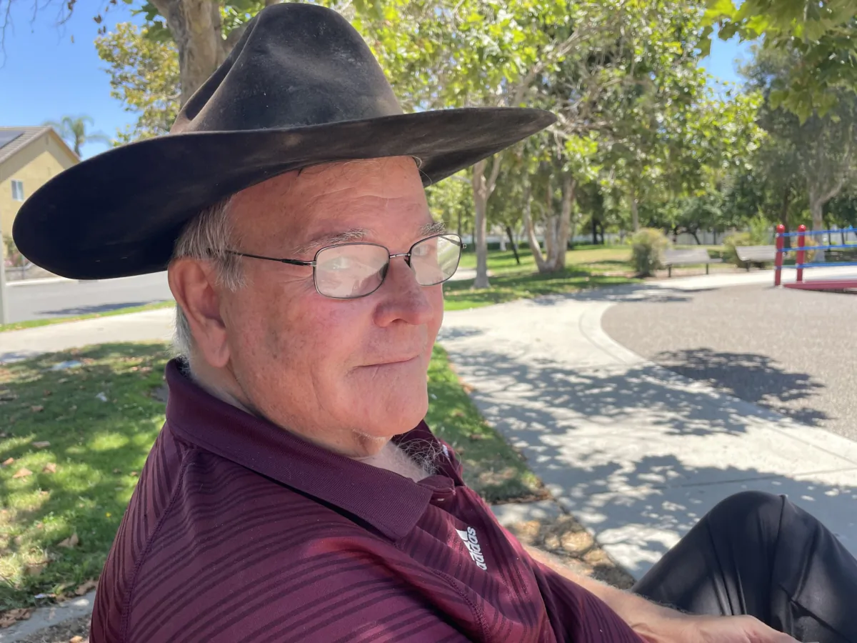 Rancher and 5 Bar Beef owner Frank Fitzpatrick sitting on a park bench in Cypress, Calif., on July 27, 2023. (Carol Cassis/The Epoch Times)