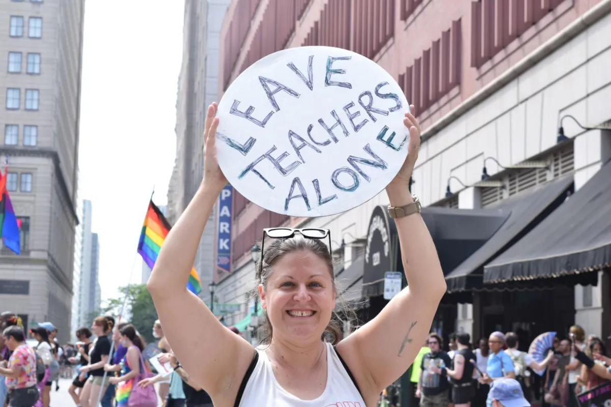 Woman poses for photo at the "dance protest" opposing the Moms for Liberty national summit in Philadelphia on July 1, 2023. (Beth Brelje/The Epoch Times)