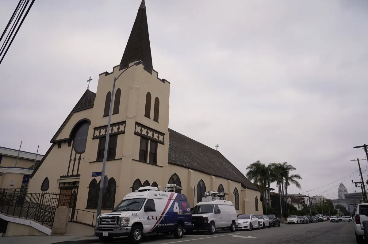 News media vans are parked outside St. Anthony Croatian Catholic Church in Los Angeles on June 14, 2023. (Damian Dovarganes/AP Photo)