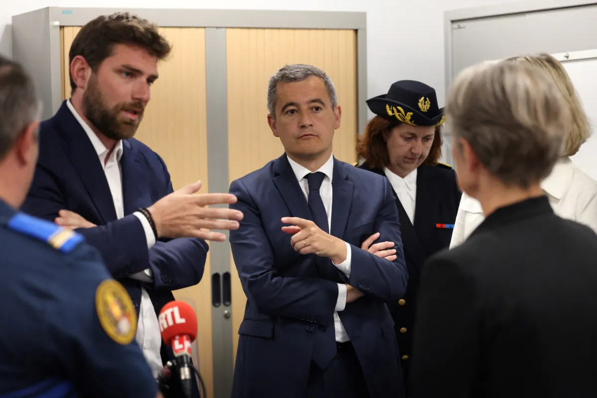 French Prime Minister Elisabeth Borne (R), and Interior Minister Gerald Darmanin (C) talks to Vincent Jeanbrun, the Mayor of L'Hay-les-Roses (L) as they meet with municipal police, after rioters rammed a vehicle into the mayor's house overnight, in L'Hay-les-Roses, south of Paris, on July 2, 2023. (Charly Triballeau/Pool/AFP via Getty Images)