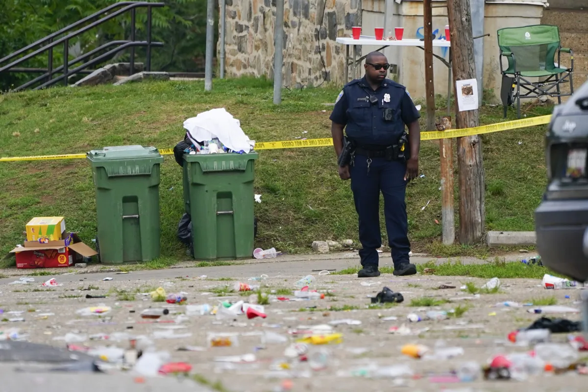 A police officer stands in the area of a shooting incident in the Southern District of Baltimore on July 2, 2023. (Julio Cortez/AP Photo)