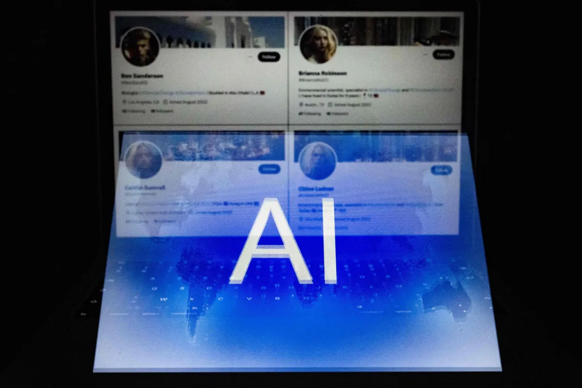 This illustration photograph taken in Helsinki on June 12, 2023, shows an AI (artificial intelligence) logo blended with four fake Twitter accounts bearing profile pictures apparently generated by artificial intelligence software. (Olivier Morin/AFP via Getty Images)