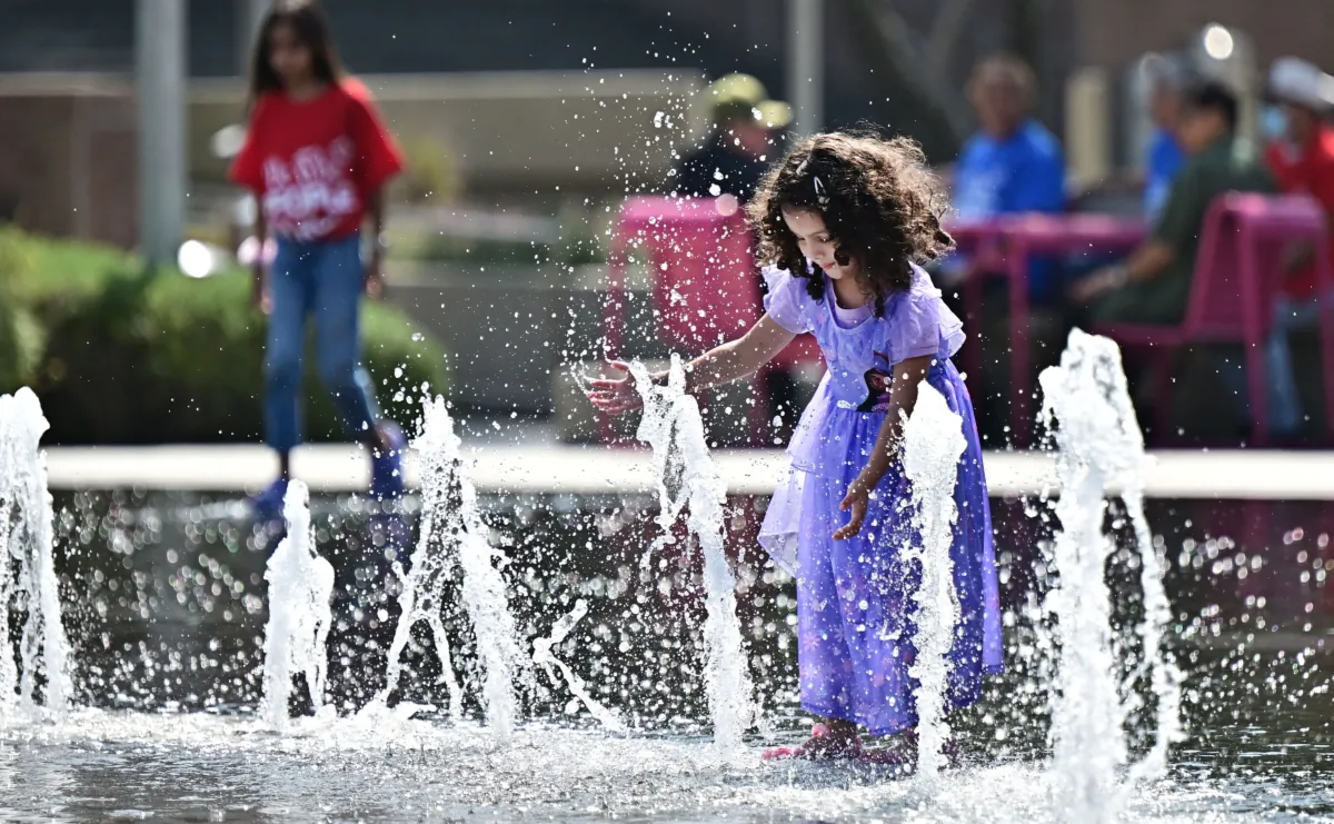 A child plays in the water fountain at Grand Park in Los Angeles, on July 2, 2023. (Frederic J. Brown/AFP via Getty Images)