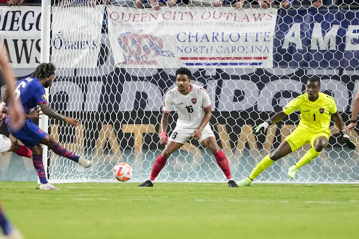 United States midfielder Gianluca Busio scores past Trinidad and Tobago's Alvin Jones and goalkeeper Marvin Phillip during the second half of a CONCACAF Gold Cup soccer match in Charlotte on July 2, 2023. (Chris Carlson/(AP Photo)