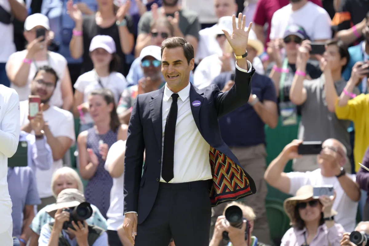 Switzerland's Roger Federer waves during a 100 years of Centre Court celebration on day seven of the Wimbledon tennis championships in London on July 3, 2022. (Kirsty Wigglesworth/AP Photo)