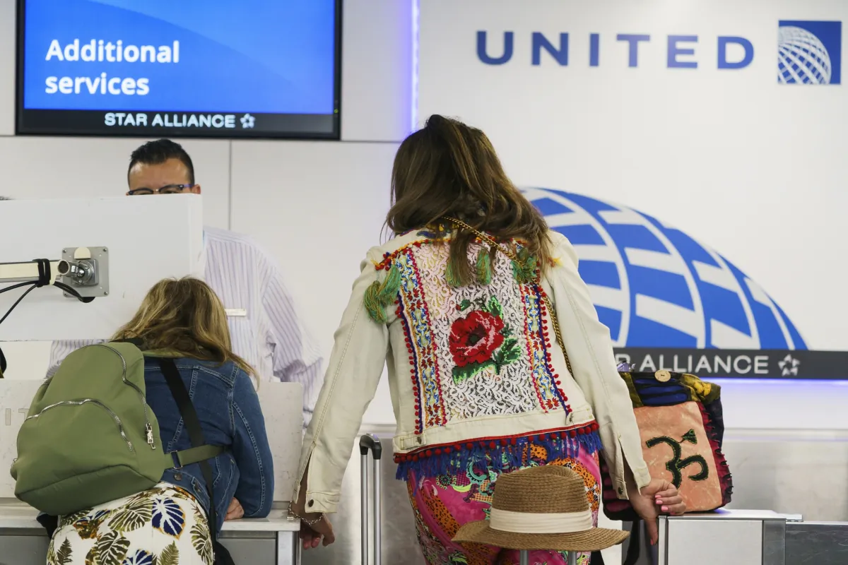 Travelers check-in at the United Airlines terminal at Los Angeles International Airport in Los Angeles on June 28, 2023. (Damian Dovarganes/AP Photo)