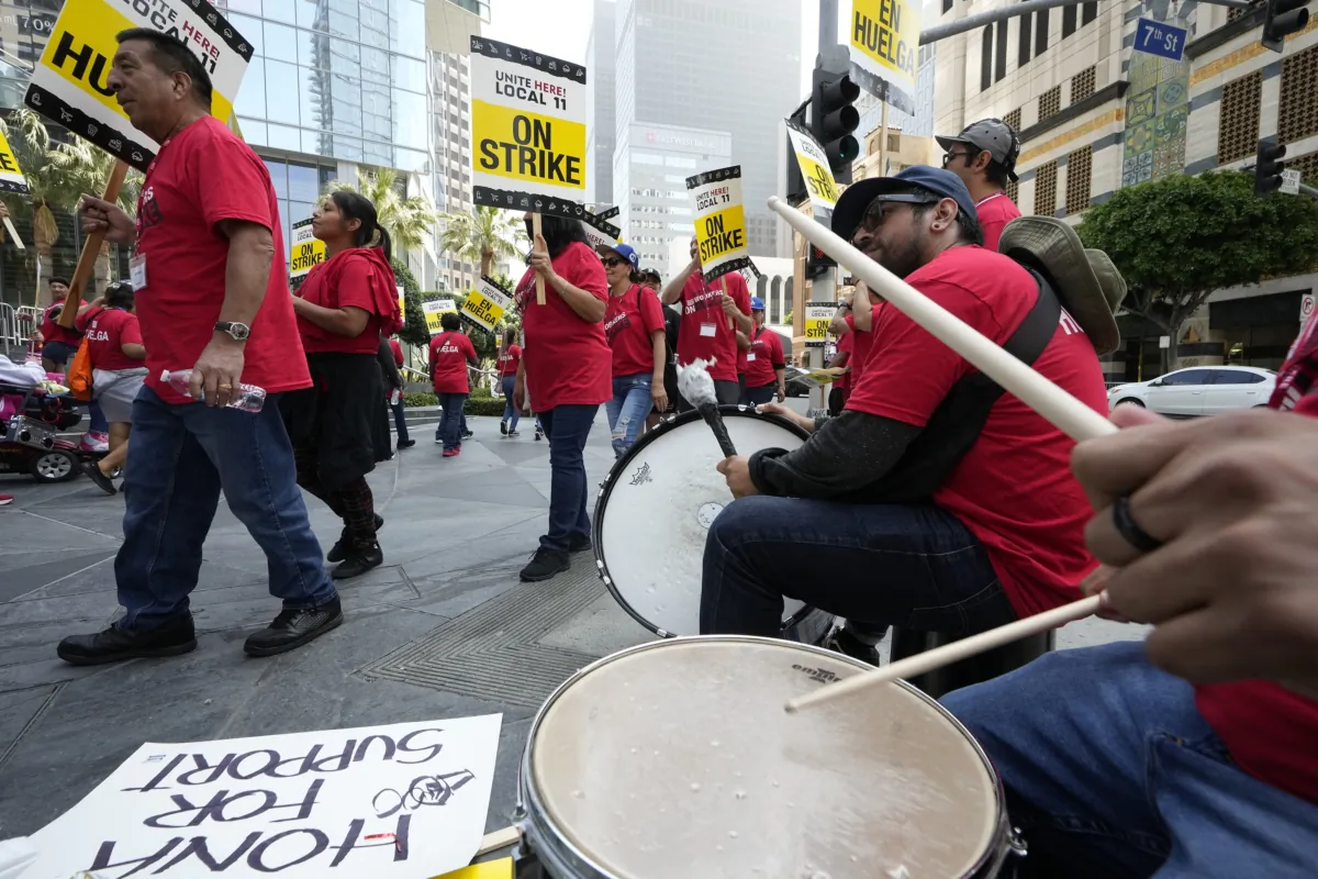 Striking hotel workers play drums as they rally outside the Intercontinental Hotel in downtown Los Angeles on July 3, 2023. (Damian Dovarganes/AP Photo)