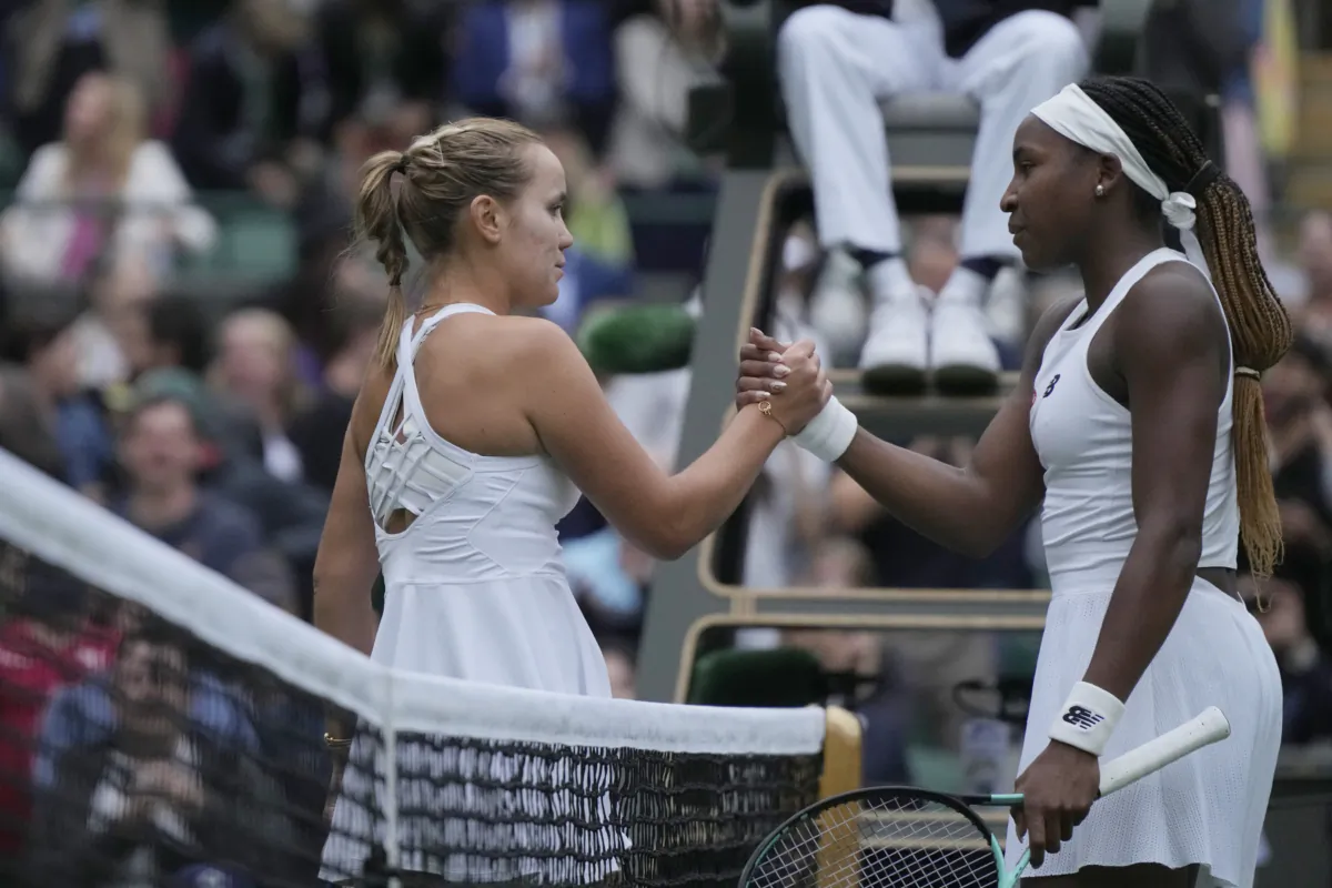 Sofia Kenin of the United States (L) shakes hands with Coco Gauff of the United States after winning the first round women's singles match on day one of the Wimbledon tennis championships in London on July 3, 2023. (Alastair Grant/AP Photo)