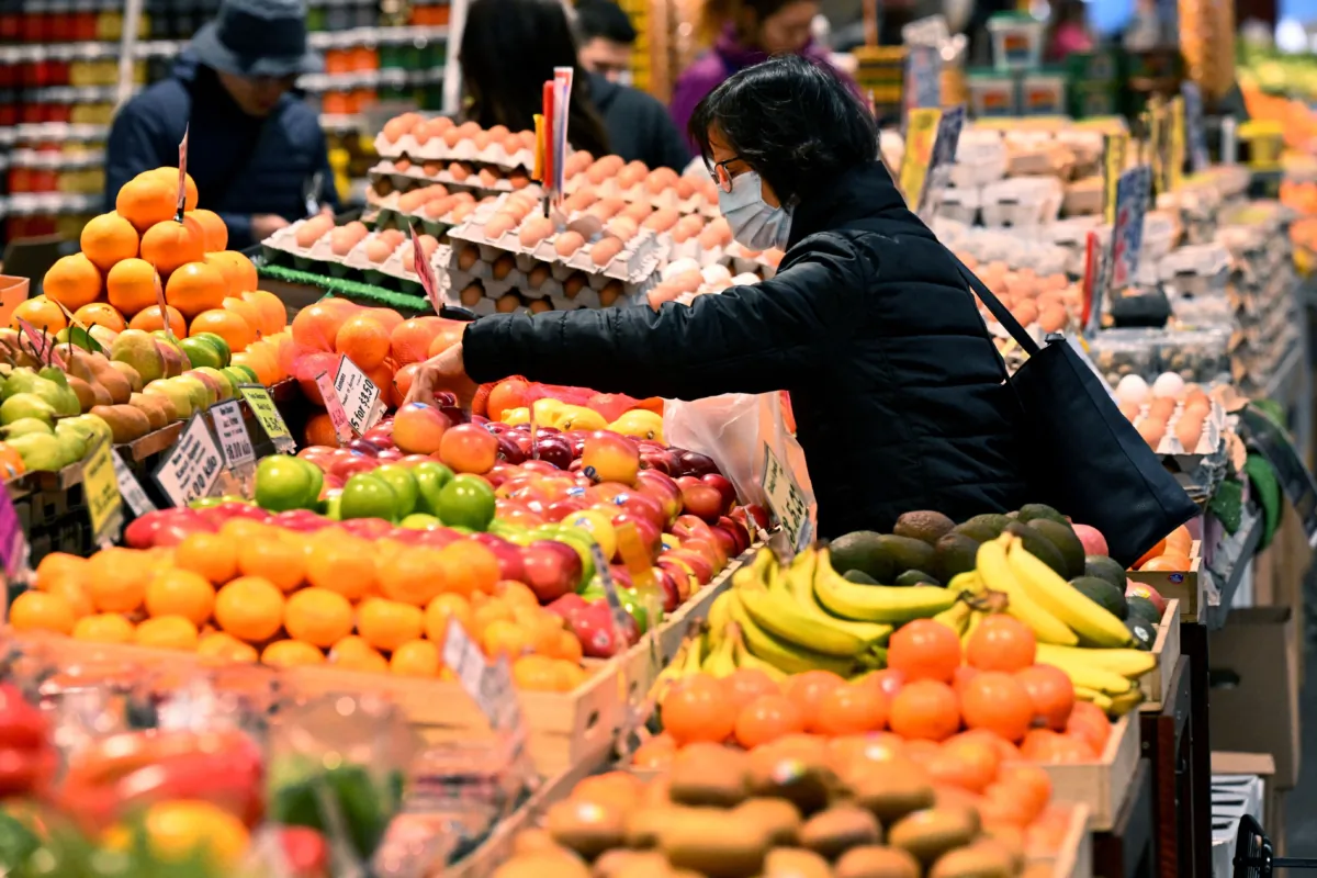 People shop for fresh produce at the Queen Victoria Market in Melbourne on July 4, 2023, after the Reserve Bank of Australia (RBA) surprised analysts by leaving interest rates on hold at 4.1 per cent in July. (William West/AFP via Getty Images)