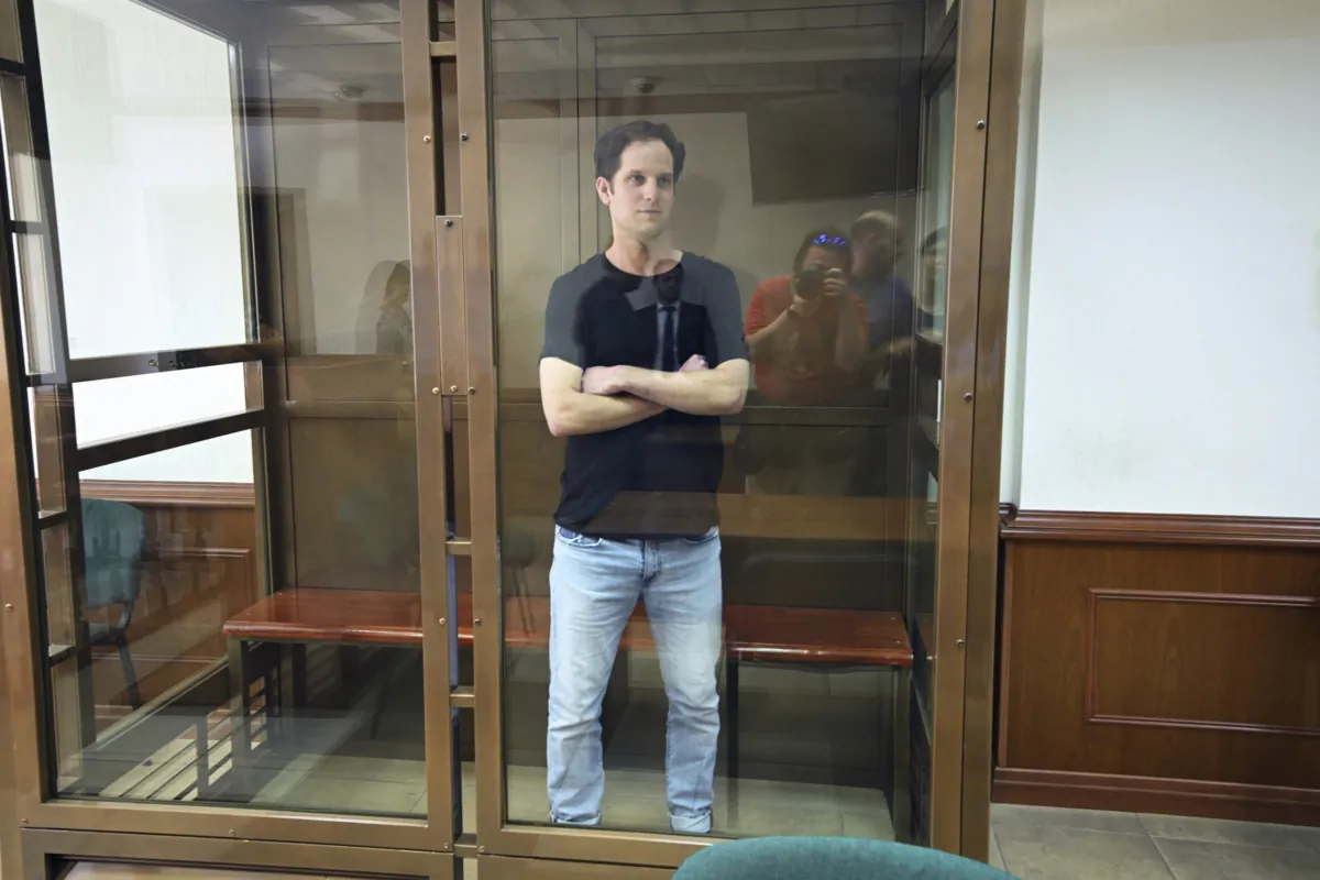 Wall Street Journal reporter Evan Gershkovich stands in a glass cage in a courtroom at the Moscow City Court in Moscow on June 22, 2023. (Dmitry Serebryakov/AP Photo)