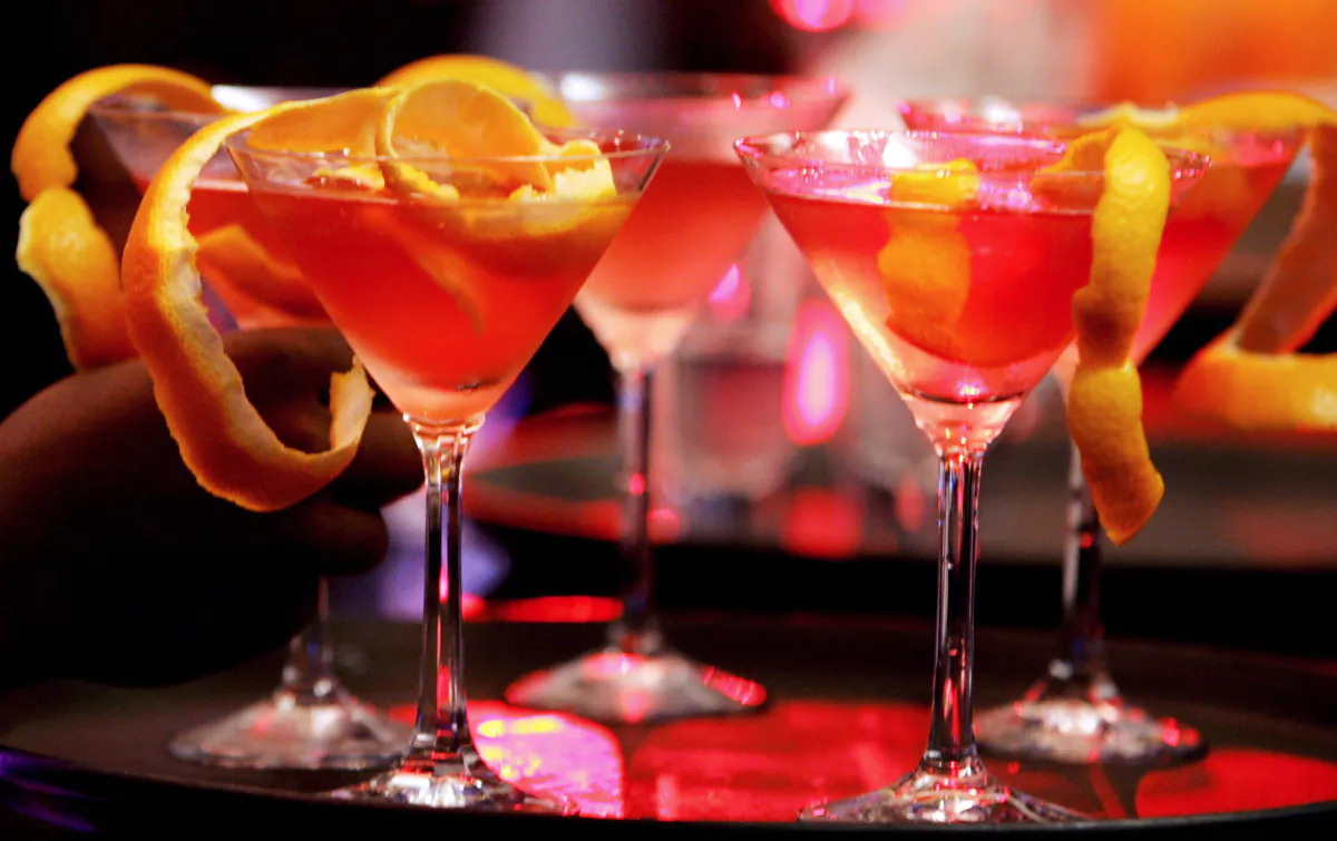 Bar waiters prepare a cocktail based on the Russian premium Vodka Eristoff during its launch by Bacardi Martini India Limited in Bangalore on May 30, 2007. (Dibyangshu Sarkar/AFP via Getty Images)