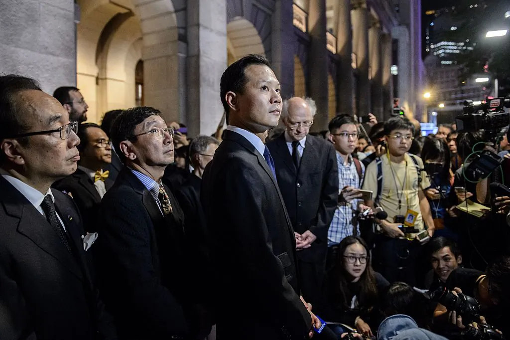 Dennis Kwok (C) stands outside the Court of Final Appeal in Hong Kong on Nov. 8, 2016, after a silent march in protest of a ruling by China which effectively bars two pro-independence legislators from taking office. (Anthony Wallace/AFP via Getty Images)