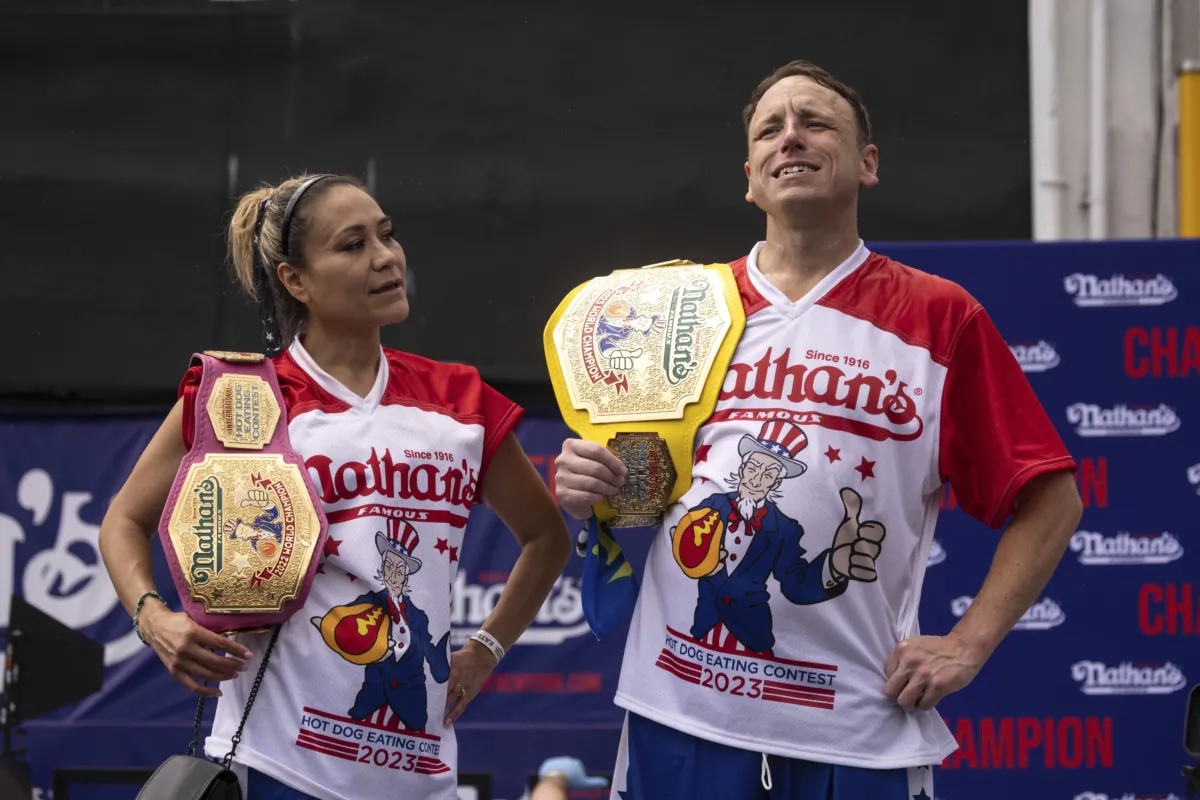 This year's woman's champion Miki Sudo (L) and man's champion Joey Chestnut (R) stand together during the 2023 Nathan's Famous Fourth of July hot dog eating contest in the Coney Island section of the Brooklyn borough of New York on July. 4, 2023. (Yuki Iwamura/AP Photo)