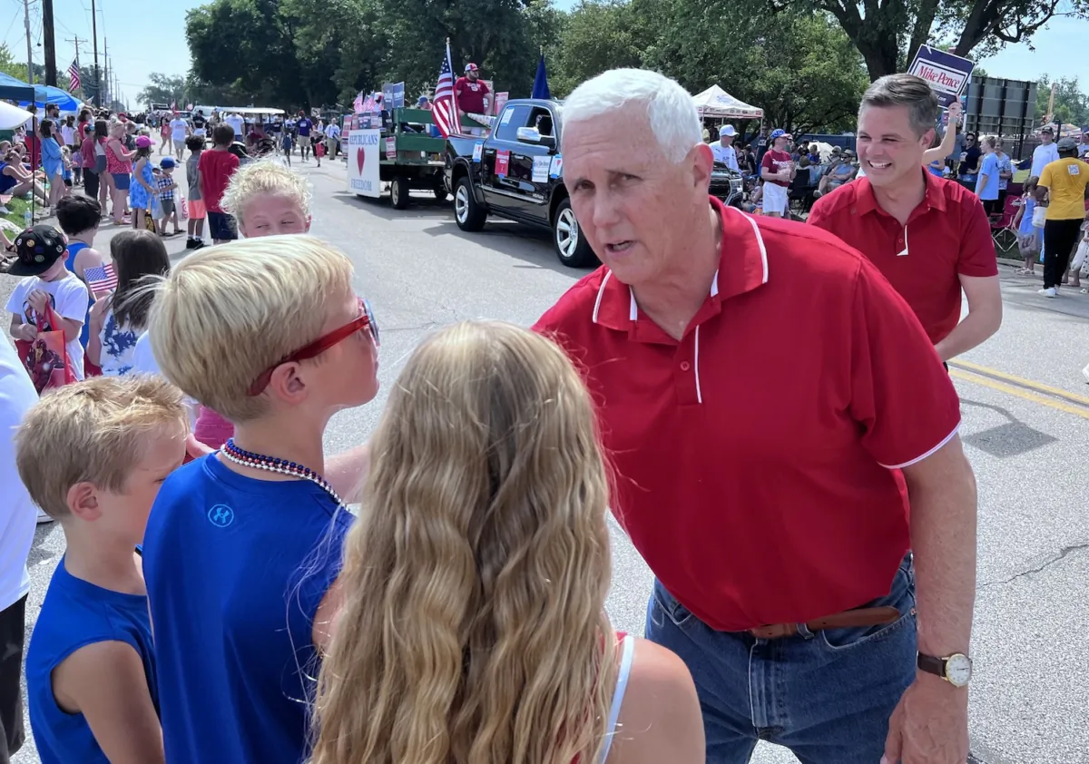 Former Vice President Mike Pence greets children at the 4th of July Parade in Urbandale, Iowa, in 2023. (Lawrence Wilson/The Epoch Times)