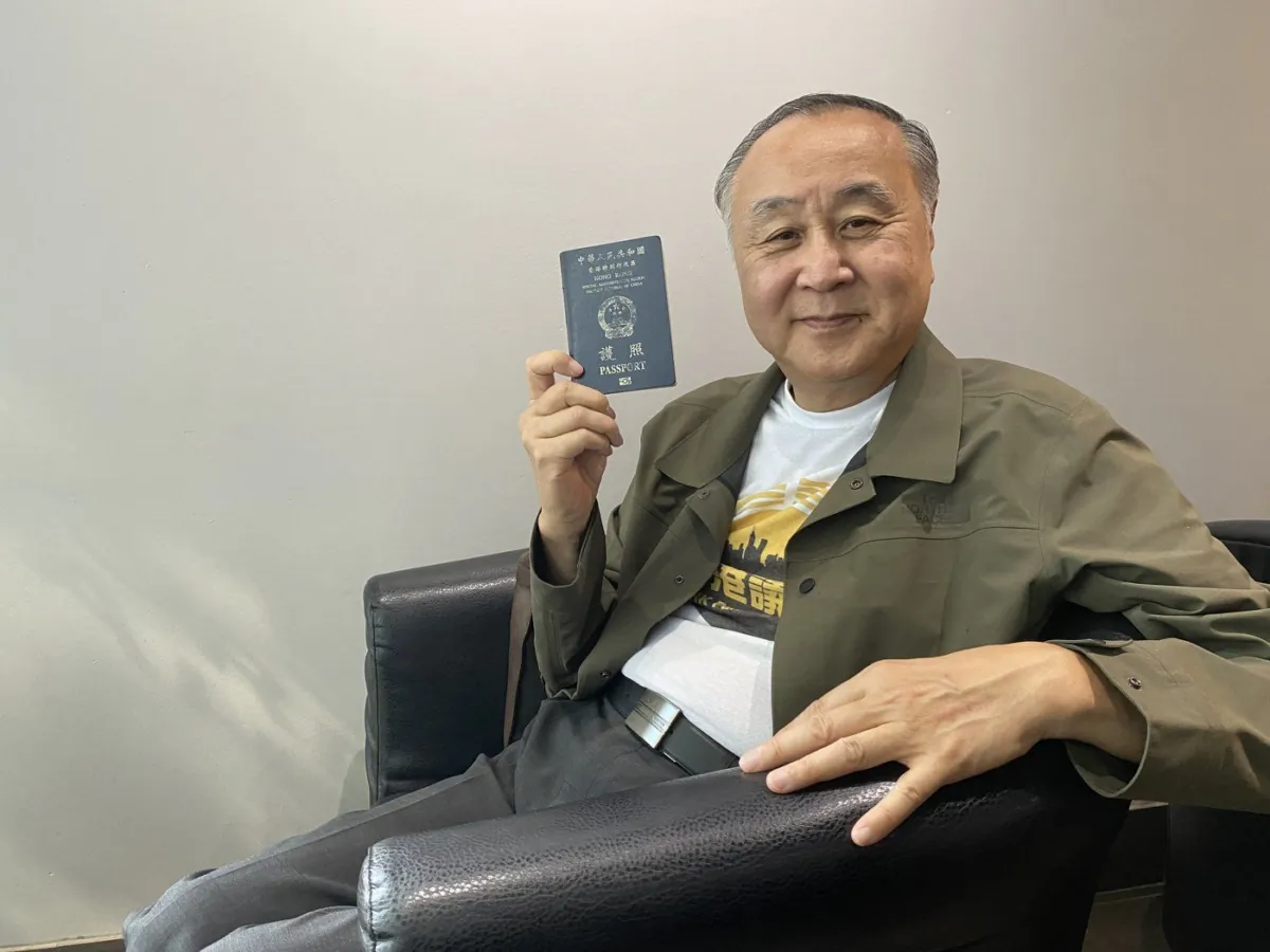 Hong Kong democracy activist Elmer Yuen shows his Hong Kong passport during an interview in Vancouver on July 5, 2023. (The Canadian Press/Nono Shen)
