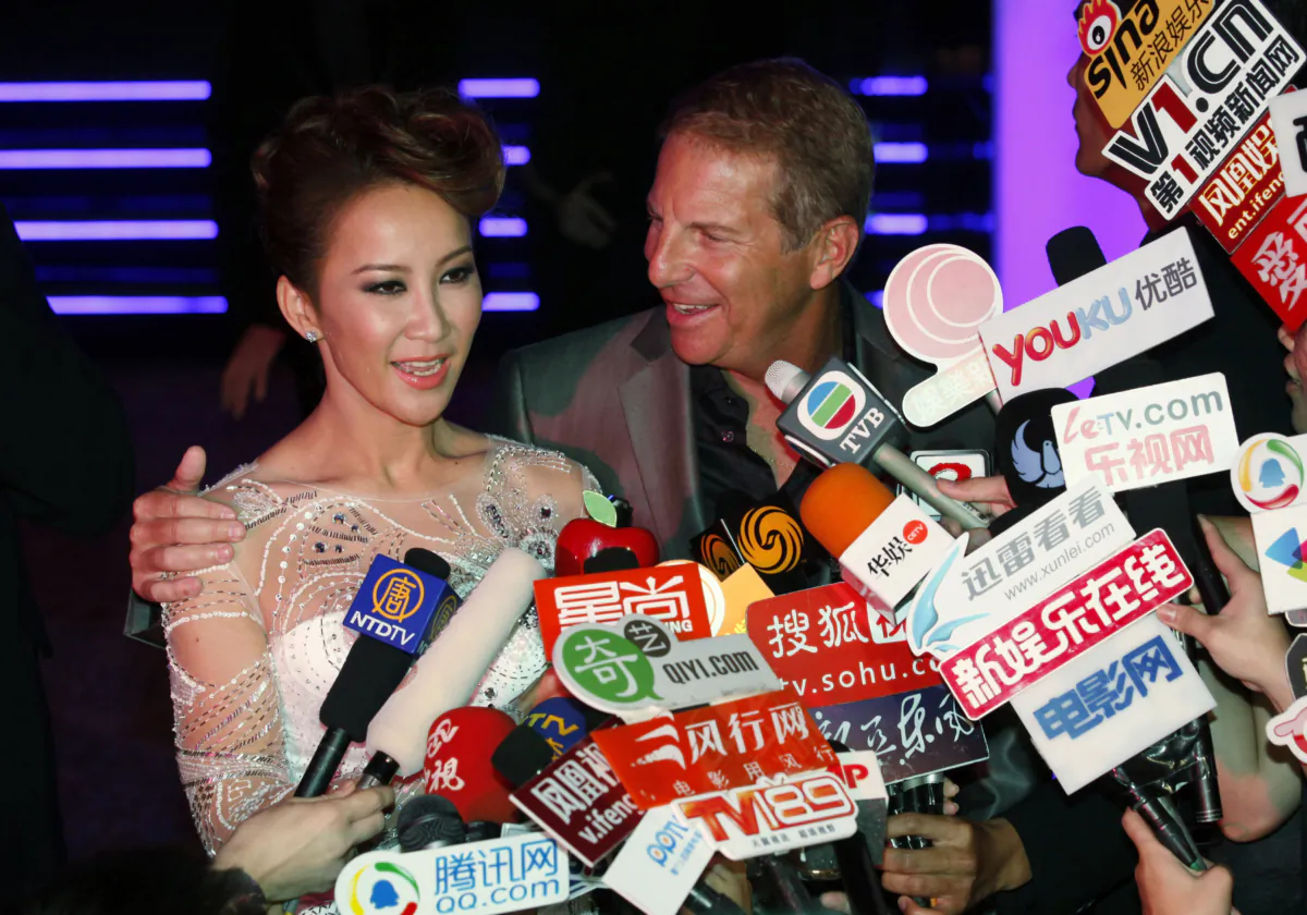 Hong Kong singer Coco Lee and her husband Bruce Rockowitz speak to media during their wedding banquet at Shaw Studio in Hong Kong on Oct. 28, 2011. (Kin Cheung/AP Photo)