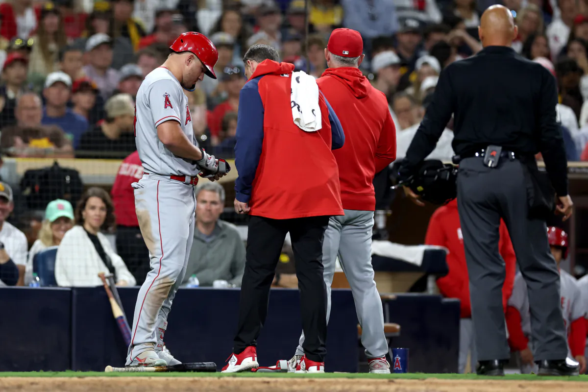 Manager Phil Nevin talks with Mike Trout (27) of the Los Angeles Angels during his at bat during the eighth inning of a game against the San Diego Padres; Trout subsequently left the game with an injury at PETCO Park in San Diego on July 3, 2023. (Sean M. Haffey/Getty Images)