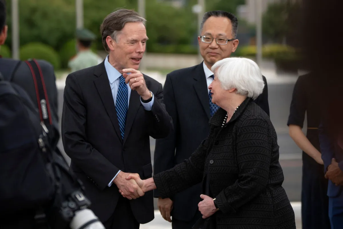 U.S. Treasury Secretary Janet Yellen (R) shakes hands with U.S. Ambassador to China Nicholas Burns (L) as Yang Yingming, director general of the Department of International Economic Relations of China's Ministry of Finance, looks on after Yellen arrived at Beijing Capital International Airport in Beijing on July 6, 2023. (Mark Schiefelbein/POOL/AFP via Getty Images)
