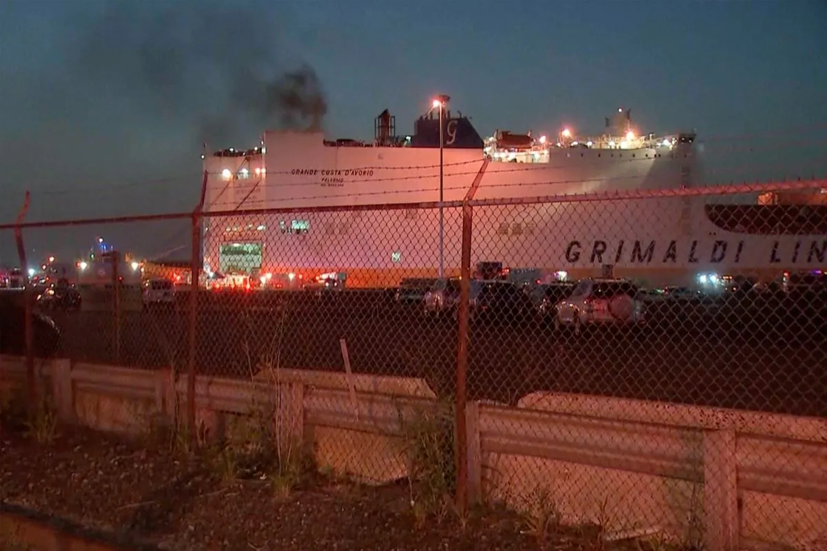 In this image taken from video, smoke rises from a cargo ship in the port of Newark, N.J., on July 6, 2023. (WABC-TV via AP)