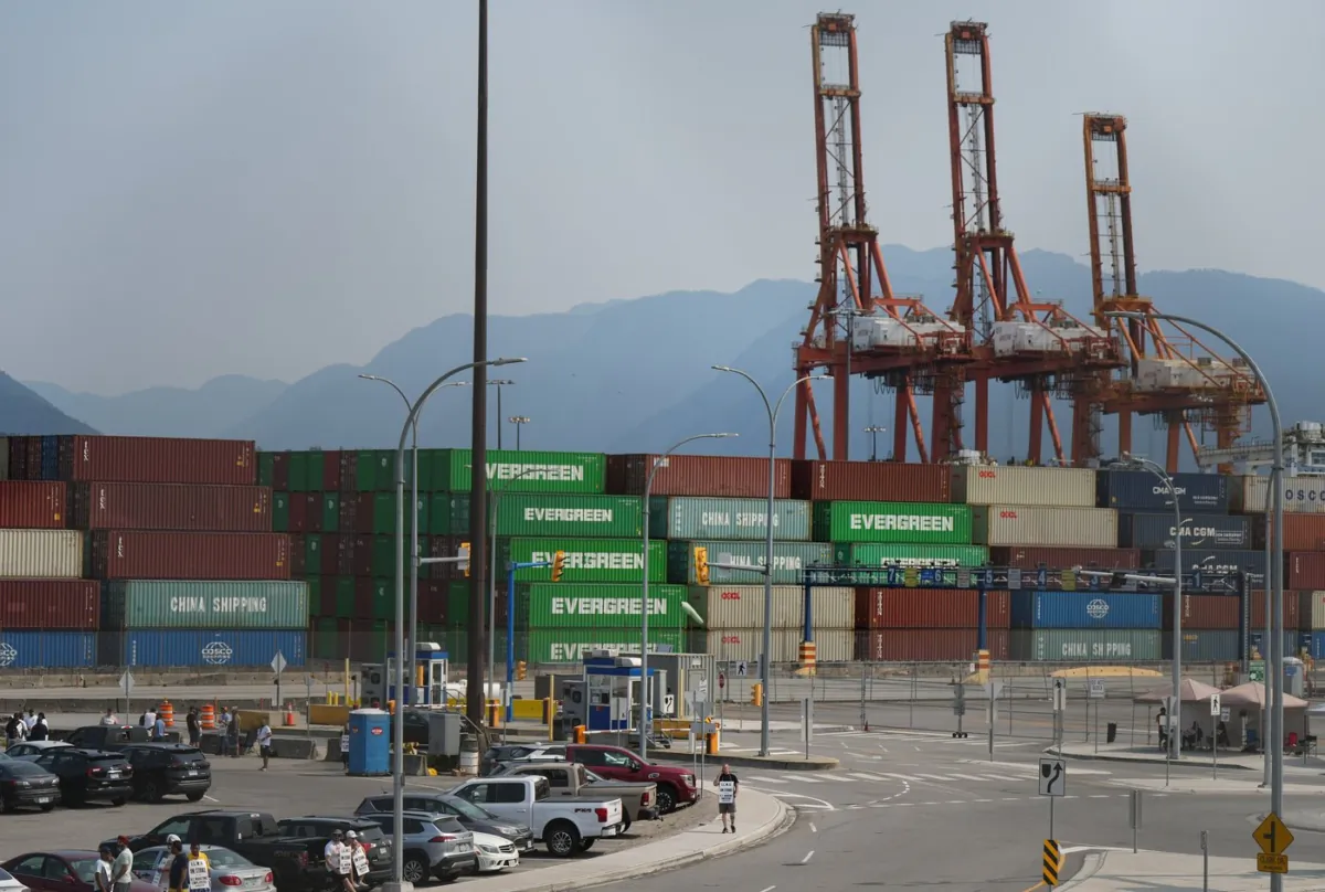 Striking International Longshore and Warehouse Union Canada workers picket at a port entrance in Vancouver, B.C., on July 4, 2023. (The Canadian Press/Darryl Dyck)