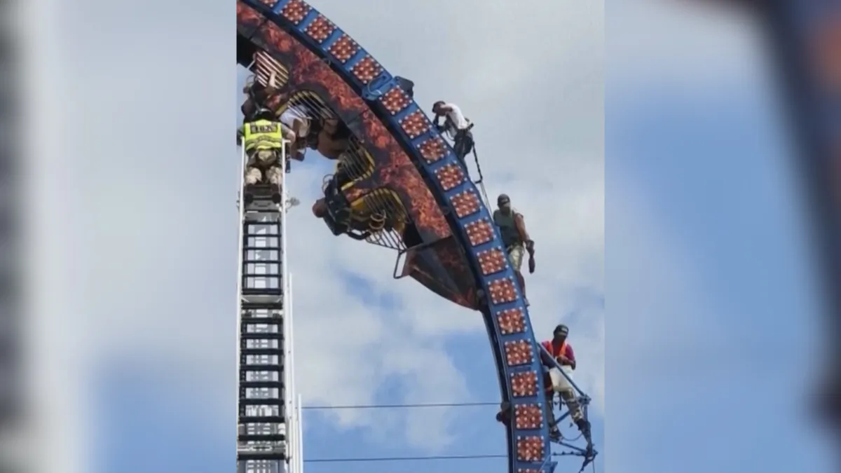 Eight people are trapped upside down on a roller coaster—some of them for more than three hours—at a festival in Crandon, Wis., on July 2, 2023, in a still from video. (Scott Brass/TMX via AP)