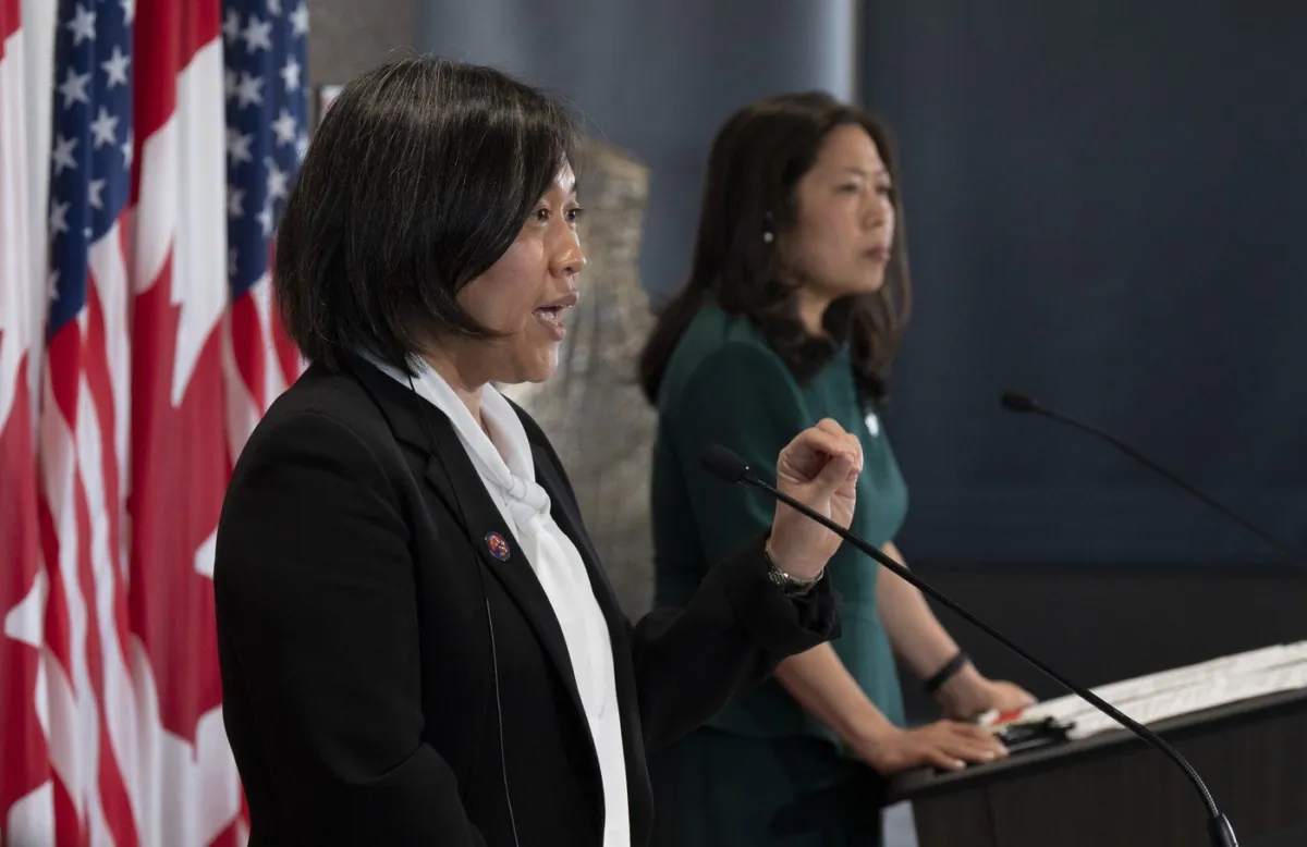 Ng, right, looks on as Tai speaks during a joint news conference in Ottawa, May 5, 2022. (The Canadian Press/Adrian Wyld)
