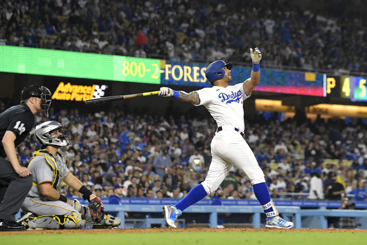 Los Angeles Dodgers' David Peralta (R) hits a solo home run as Pittsburgh Pirates catcher Austin Hedges, center, and home plate umpire Clint Vondrak watch during the fifth inning of a baseball game in Los Angeles on July 5, 2023. (Mark J. Terrill/AP Photo)
