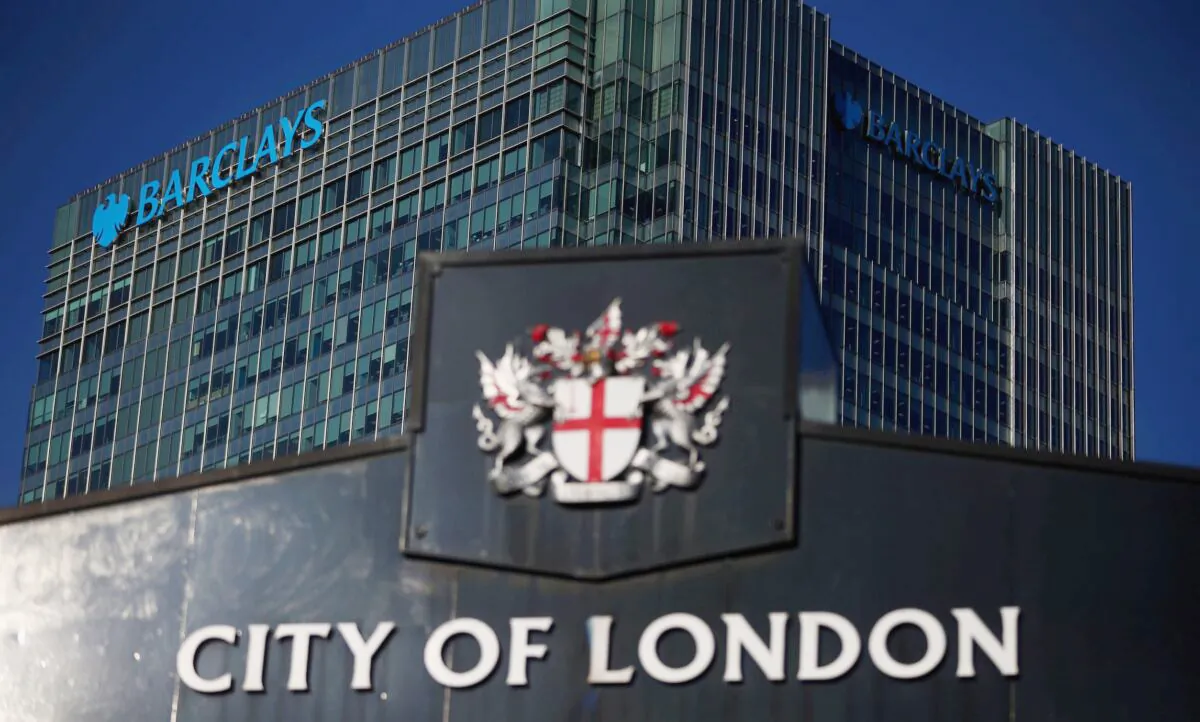 Barclays' building in Canary Wharf is seen behind a City of London sign outside Billingsgate Market in London on Aug. 8, 2018. (Hannah McKay/Reuters)