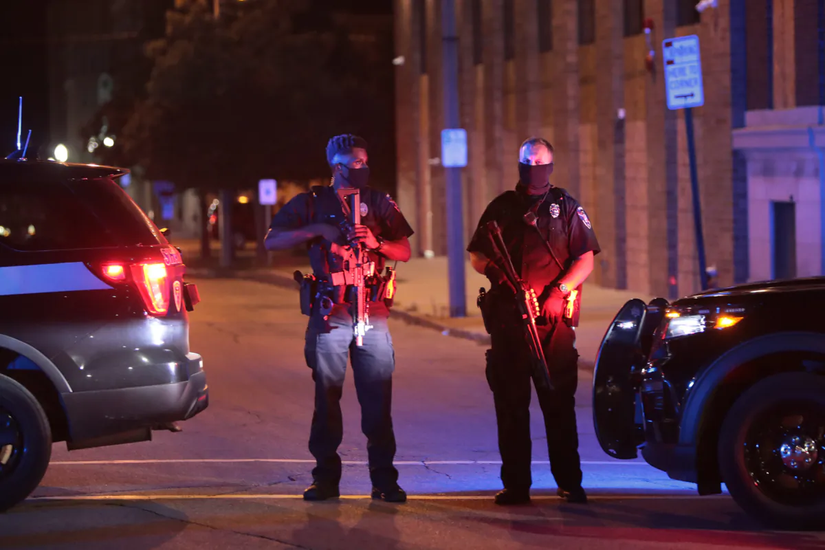 In a photo taken by Getty Images's Scott Olson, police block a road as they try to contain demonstrators gathered in the downtown area during a third night of unrest on in Kenosha, Wisconsin, on Aug 25, 2020. (Scott Olson/Getty Images)