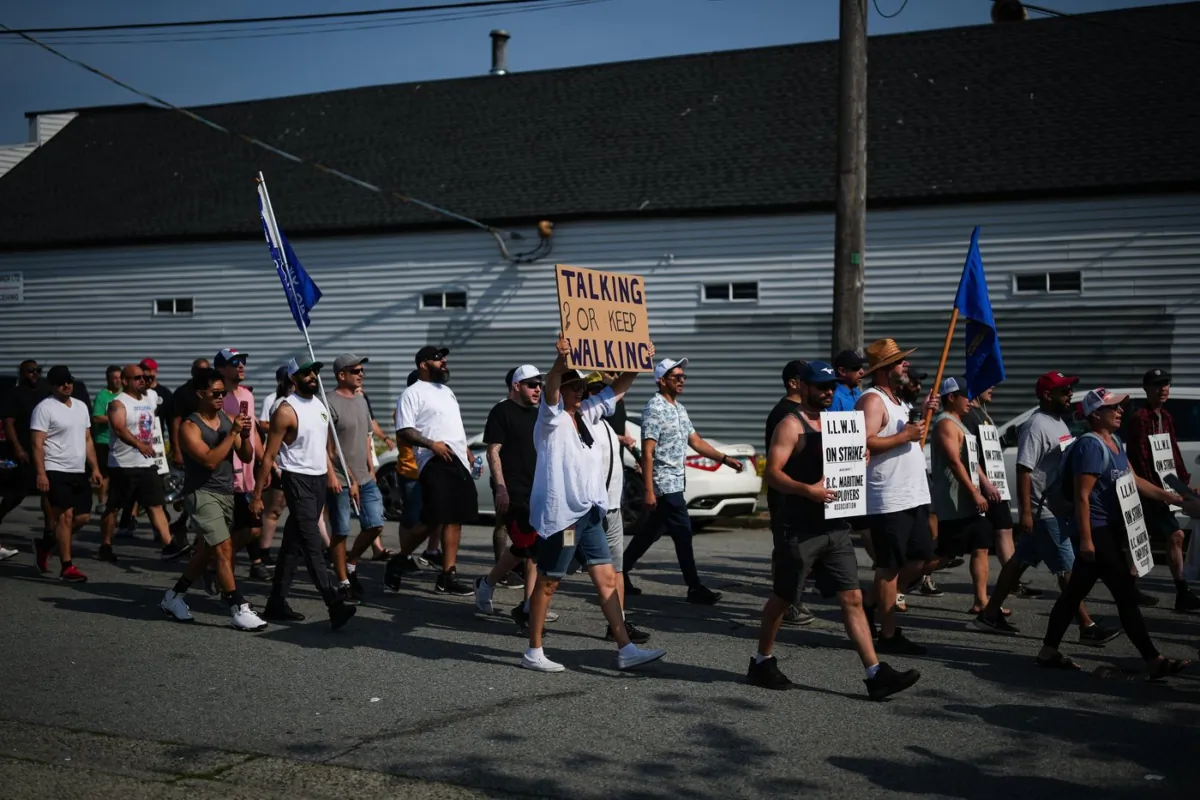 Striking International Longshore and Warehouse Union Canada workers march from the port to a rally in Vancouver on July 6, 2023. (The Canadian Press/Darryl Dyck)