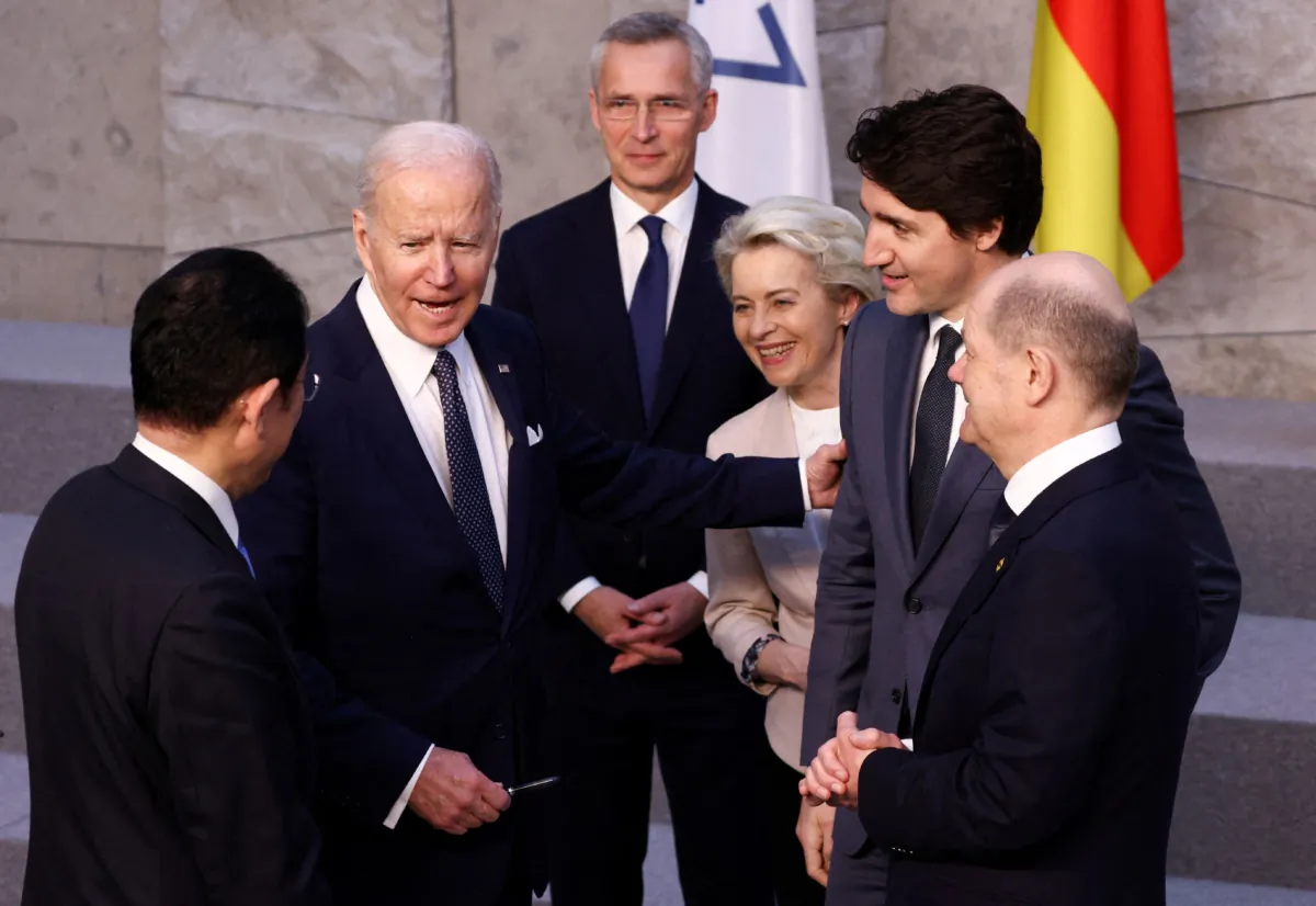 Japanese Prime Minister Fumio Kishida (L) U.S. President Joe Biden (2L) and German Chancellor Olaf Scholz (R) speak next to NATO Secretary General Jens Stoltenberg (C), European Commission President Ursula von der Leyen (3R) and Canadian Prime Minister Justin Trudeau (2R) before a G-7 leaders' family photograph during a NATO summit at the alliance's headquarters in Brussels on March 24, 2022. (Henry Nicholls/Pool/AFP via Getty Images)