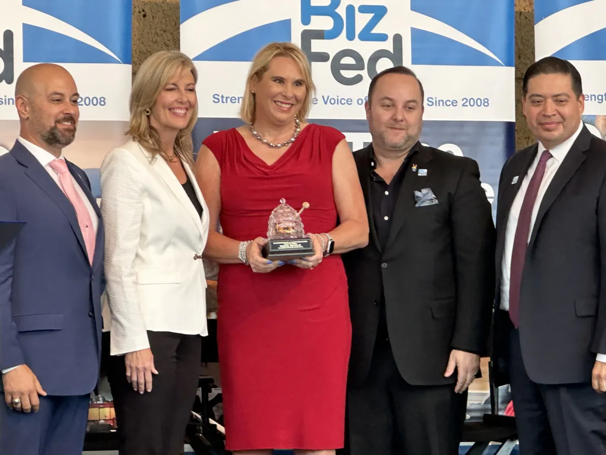 Rachel Michelin (C), president of the California Retailers Association, accepts the “Queen Bee” award at the 2nd Annual Bizzi Awards held at the Japanese American National Museum in the Little Tokyo District of Los Angeles on June 28, 2023. (Jill McLaughlin/The Epoch Times)
