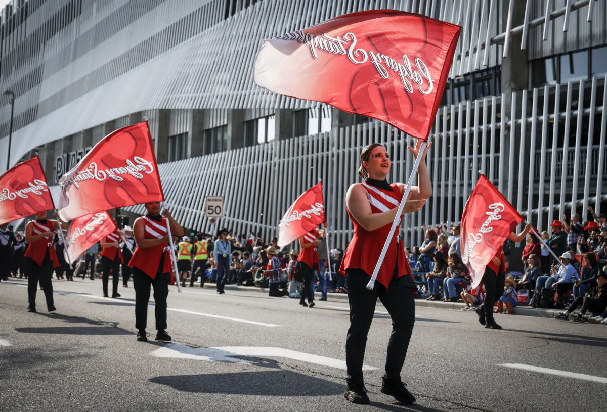 Flag bearers start the Calgary Stampede parade in Calgary on July 7, 2023. (Jeff McIntosh/The Canadian Press)