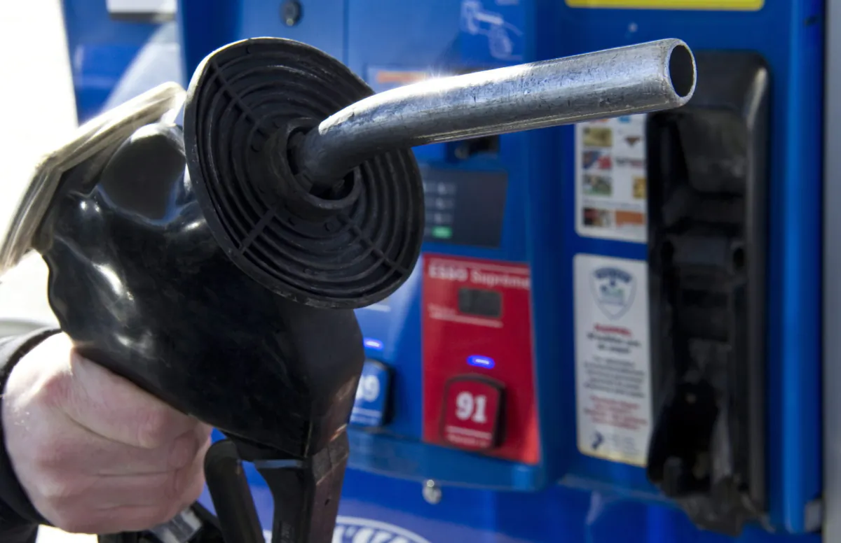 A man replaces the nozzle after filling up at a gas station in Montreal in a file photo. (The Canadian Press/Paul Chiasson)