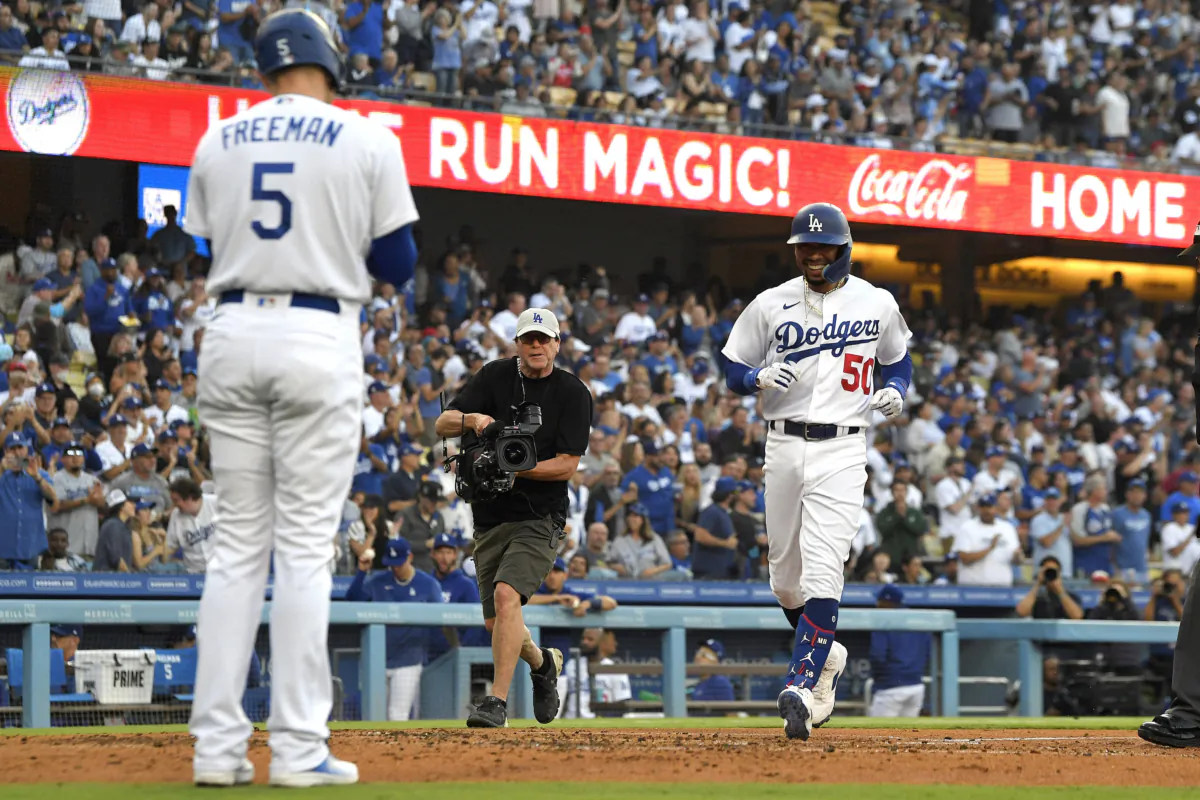 Los Angeles Dodgers' Mookie Betts (R) scores after hitting a solo home run as Freddie Freeman waits to congratulate him during the third inning of a baseball game against the Los Angeles Angels in Los Angeles on July 7, 2023. (AP Photo/Mark J. Terrill)
