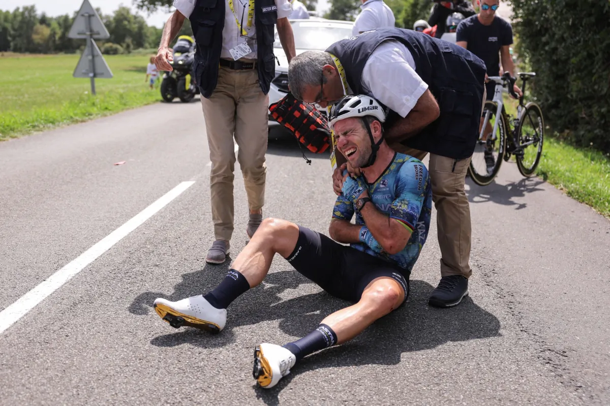 Astana Qazaqstan Team's British rider Mark Cavendish receives medical attention after crashing during the 8th stage of the 110th edition of the Tour de France cycling race, 201 kilometers between Libourne and Limoges, in central western France, on July 8, 2023. (Thomas Samson/AFP via Getty Images)