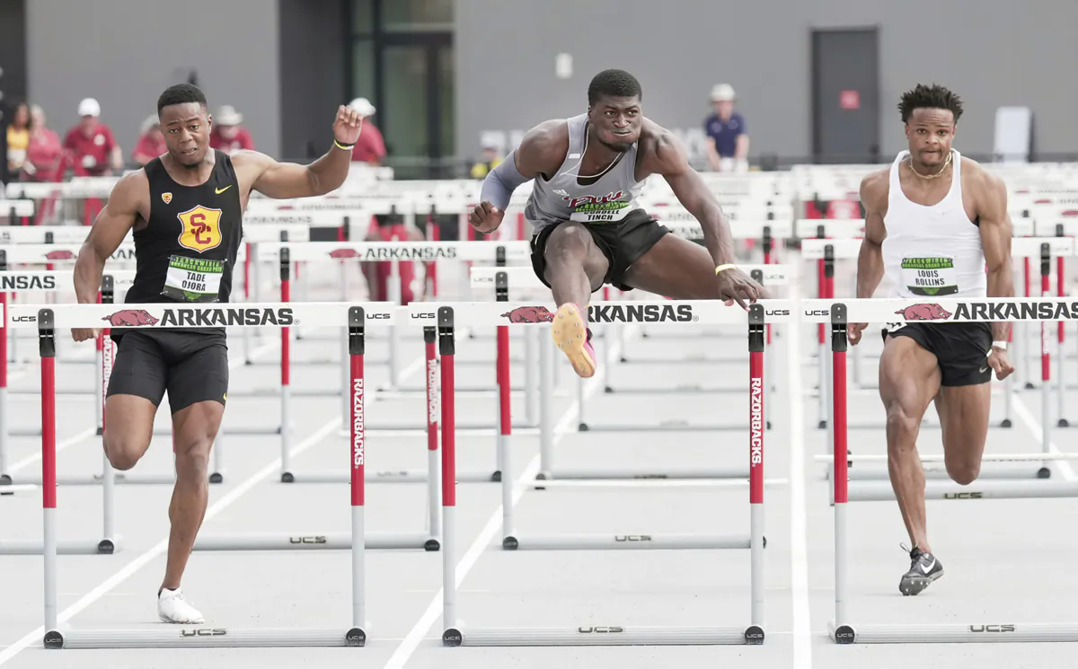 Pittsburg State hurdler Cordell Tinch (C) is competing against British hurdler Tade Ojora of USC (L) and Louis Rollins (unattached) in the 110m hurdles final at the Arkansas Grand Prix athletics event in Fayetteville, Ark., on June 23, 2023. (Shawn Price/Pittsburg State via AP)