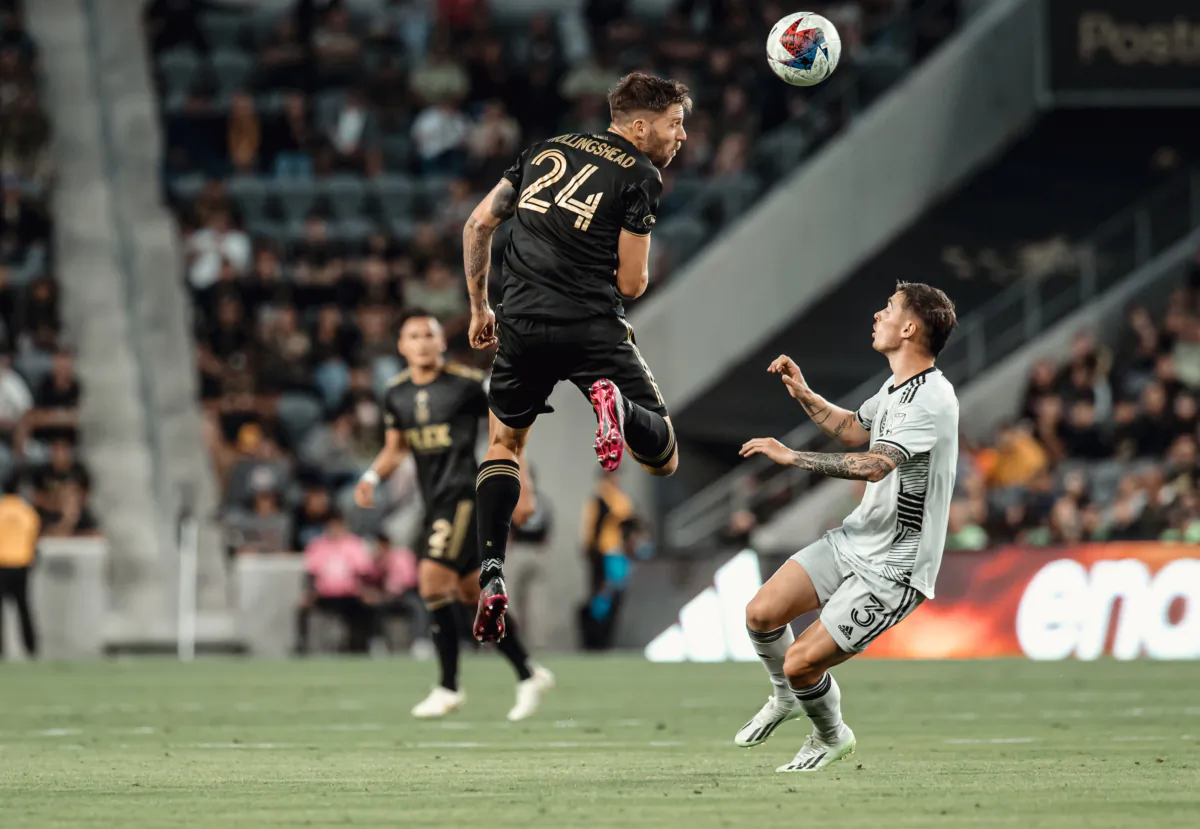 Los Angeles FC defender Brian Hollingshead (24) plays a header against San Jose Earthquakes midfielder Paul Marie (3) at BMO Stadium in Los Angeles on July 8, 2023. (Courtesy of LAFC via The Epoch Times)