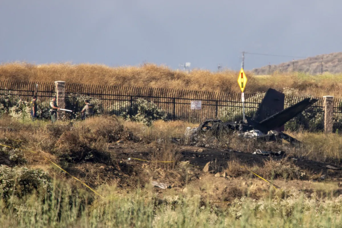 Charred remains of a Cessna lie near the landing approach at French Valley Airport, in Murrieta, Calif., on July 8, 2023. (Irfan Khan/Los Angeles Times via AP)